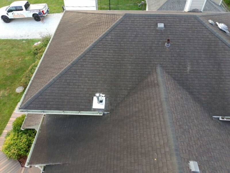 Aerial view of house with brand new dark brown roof shingles